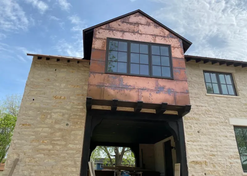 Copper metal panel facade on a stone building for Skylight Installation in Virginia