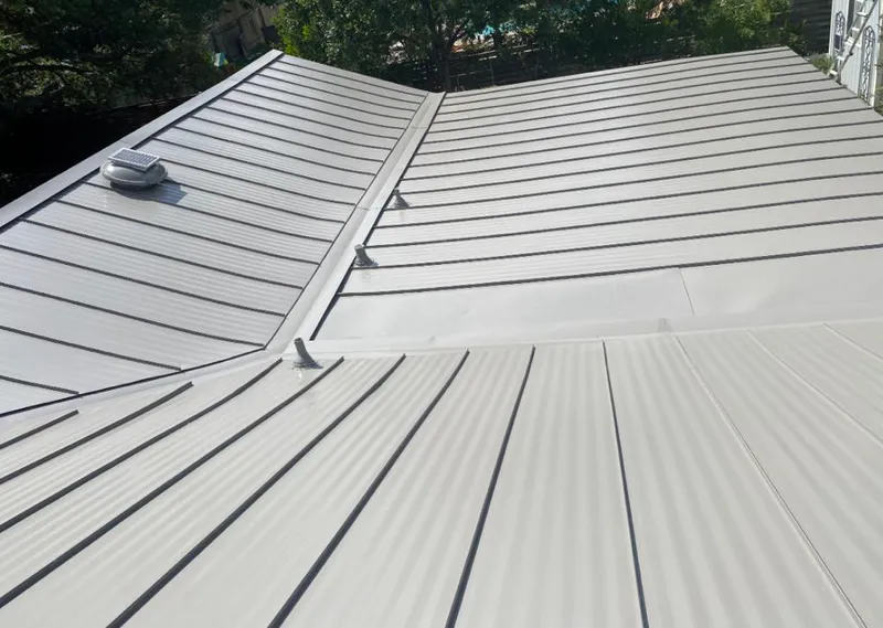 Solar attic fan installed on a metal roof for Roof Ventilation in Virginia